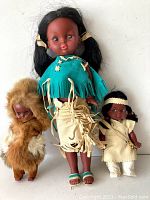 Three vintage First Nations Canada dolls with varied traditional outfits