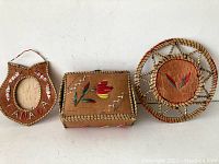 Front view of all three First Nations items together on white background showing box, frame, and round decor.
