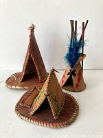 Three decorative First Nations style teepees displayed together on a white background, showing front and side views of each teepee.