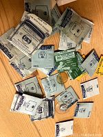 Various sealed vintage watch crystal lens packages in original paper envelopes, some labeled G-S Flexo Crystals.