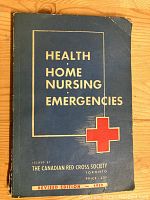 Front cover of the blue soft cover book titled 'Health Home Nursing Emergencies' issued by The Canadian Red Cross Society Toronto with a red cross symbol and 'Revised Edition 1939' printed on the front.