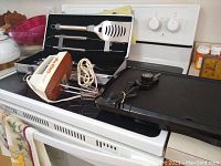 Presto electric griddle and Robeson vintage hand mixer on stove top