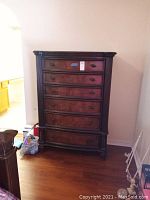 Full front view of the tall dresser showing all five drawers and overall form