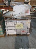 Pallet with multiple cartons of ceramic tiles wrapped in plastic. Yellow note indicating '40 CTNS 12x24 Spritzer'.