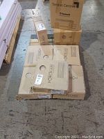 Six cartons of rectangular beige porcelain tile boxes stacked on a pallet with three cartons of vinyl tiles in cardboard boxes labeled Tandus Centiva Tarkett.