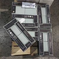 Six boxes of Harmony single fired white clay ceramic tiles in mint color stacked on a pallet.