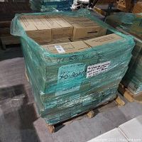 Pallet wrapped with 46 boxes of American Olean wall tile showing quantity and some labeling.