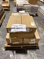 Stacked boxes on pallet labeled as American Olean 0038 wall tile, showing overall packaging condition.