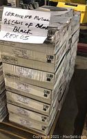 Stacked 26 boxes wrapped with plastic, label written 'Ceramiche Mutina 26 cboxes of black REX 05'