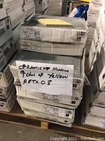 Nine stacked boxes of Ceramiche Mutina yellow tile RETX08 labeled with handwritten note and printed box labels.