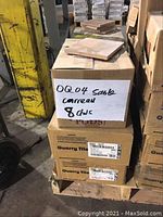 Stack of cardboard boxes on a pallet containing Quarry Tile Sand Flash tiles. One box on top labeled with product code QQ04 and quantity 8 boxes.