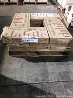 Pallet of cardboard boxes labeled 'Daltile ceramic mosaictile' stacked with a note indicating 11 boxes of custom mix sketch tile with 24.56 sq ft per carton.