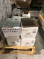 12 boxes of Metropolitan Ceramics chestnut brown tiles arranged on pallet, some boxes open showing tiles inside. One box labeled with '10 B Chestnut Brown 1 c/t + 8 pcs'.