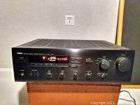 Front view of Yamaha RX-750 stereo receiver showing control panel, display, and knobs.