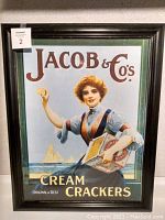 Full view of the framed vintage lithograph advertisement for Jacob & Co's Cream Crackers