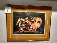 Framed limited edition print with fiery buffalo image, triple matte and glass covering, with print ratio and artist signature at the bottom.