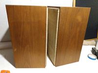Pair of rectangular teak wood speakers showing side views of cabinets with visible wood grain.