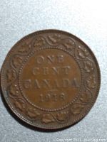 Close-up photo showing detailed text and maple leaf border on the 1918 Canadian One Cent coin.