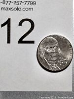 Image showing the coin against a background with a number 12 tag for lot identification.