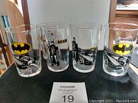 Second angle of the five themed glass tumblers displaying the Batman characters, logos, and the Disney Dalmatian design for clarity.