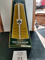 Original green and yellow box with tempo chart and Wittner METRONOM System Malzell branding, showing the metronome's markings and origin (Made in West Germany).