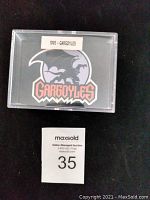Plastic display case with a Gargoyles logo sticker on the front labeled '1995 - Gargoyles'