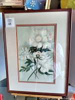 Framed watercolor painting of white flowers under glass, showing the full artwork and framing condition.