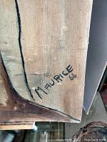 Close-up of artist's signature 'Maurice 66' in black ink on the bottom right corner of the board.