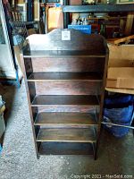 Alternate angle front view of the same vintage bookshelf highlighting the wood grain, shelf spacing, and overall vintage condition.