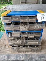 Front and side view of blue plastic organizer bin with multiple clear drawers full of assorted metal hardware including cotter pins, nuts, bolts, and washers
