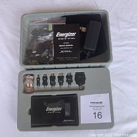 View of the portable charger, user manual, power adapter, carrying pouch, multiple connectors packed in a compartmentalized plastic case.