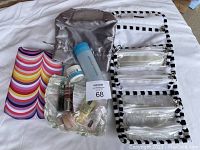 Photo of all beauty products and cosmetic bags arranged on a white sheet showing all items including Clinique and Rodan + Fields products, and cosmetic bags.