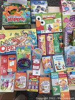 Photo overview of various children's games including Hungry Hungry Hippos, Operation, Memory game, flash cards, and toys.