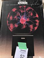 Original packaging box with branding Eye of the Storm showing plasma ball graphic and title.