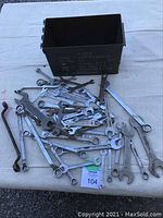 Photo showing all wrenches laid out on a table alongside the open military ammo can
