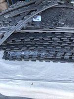 Stack of black foam interlocking floor mat pieces with texture and edge pieces.