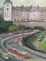 Close-up view of cityscape showing buildings and winding road with red buses and cars.