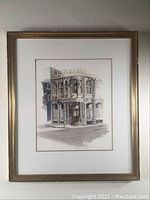 Full view of framed watercolor painting showing a corner building.