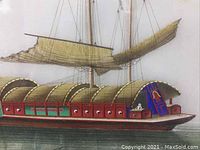 Close-up of the right side details of the junk boat, showing intricate paint detail and sail damage
