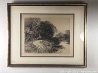 Framed vintage signed etching showing a rural road curving into a wooded area, with gold-tone frame and cream matting