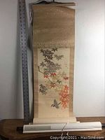 Full view of the larger scroll painting laid flat with ruler showing approximate length of 60 inches