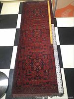 Full length image of the runner rug with measuring tape showing approximately 58 inches length and 20 inches width.