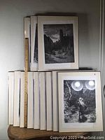 Twelve vintage Gustav Dore prints stacked and displayed from the front, showing black and white detailed gothic scenes. Includes a wooden ruler for approximate size reference.