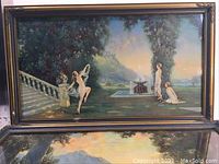 Framed print showing three figures near pool and castle background with gilt frame.