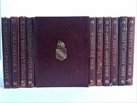 Front view of eleven red leather bound spines with gilt titles