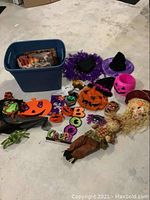 Full overview of the blue storage tote with all Halloween and fall decorative items arranged around it.
