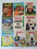 Photo of the nine MAD magazines laid out in three rows showing colorful and varied covers from the 1970s-1980s.