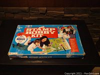 Photo of the original blue box packaging for the Stamp Hobby Kit showing vintage art and promotional text.