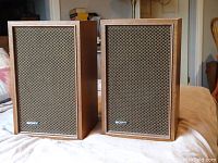 Front view of pair of vintage Sony speakers showing walnut finish, speaker grills, and Sony logo