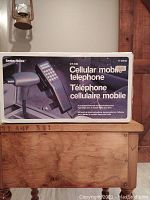 Photo of the original Radio Shack CT-100 cellular telephone box showing front with phone picture and product name.